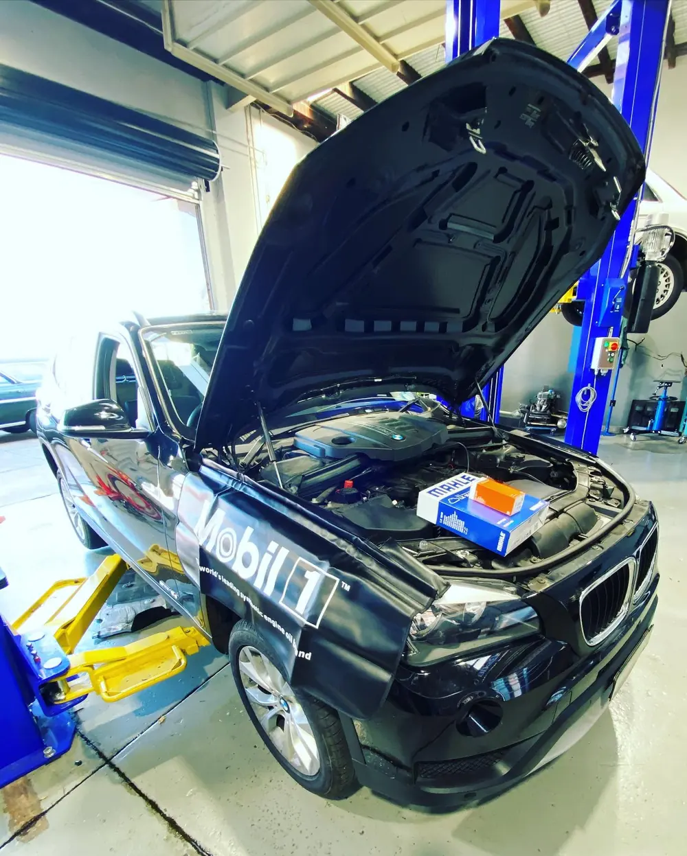 Vehicle undergoing maintenance with bonnet raised